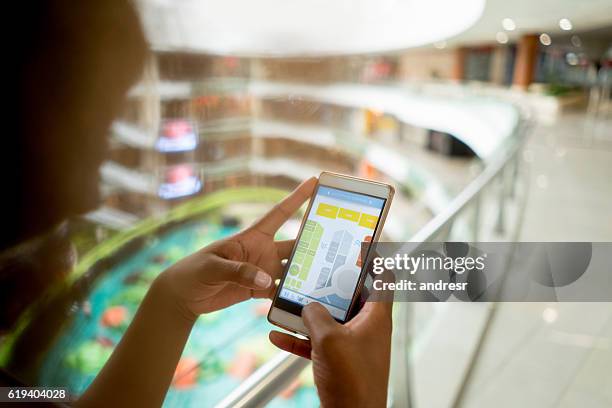 shopping woman using her cell phone at the mall - shopping centre screen stock pictures, royalty-free photos & images