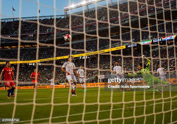 Mexico goalkeeper Guillermo Ochoa stretches out to try to block the goal in the second half during the Copa America Centerario Quarterfinal match...