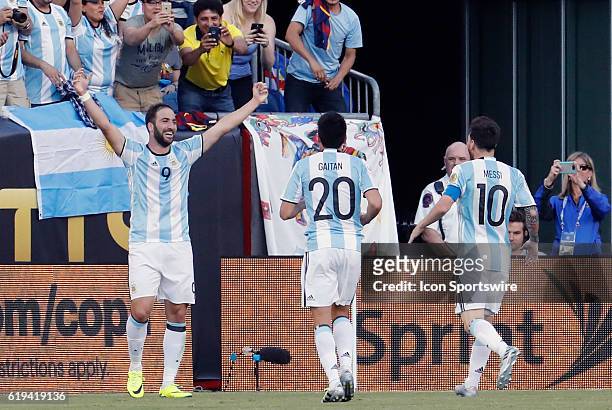 Argentina forward Gonzalo Higuain celebrates his second goal of the game as Argentina forward Nicolas Gaitan and Argentina forward Lionel Messi rush...