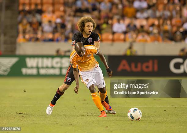 Houston Dynamo midfielder DaMarcus Beasley and D.C. United midfielder Nick DeLeon fight for ball during the MLS soccer match between DC United and...