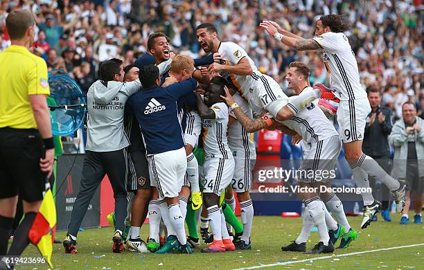 Sebastian Lletget and his Los Angeles Galaxy teammates mob teammate Giovani dos Santos, fourth from left, after dos Santos scored a goal during the...