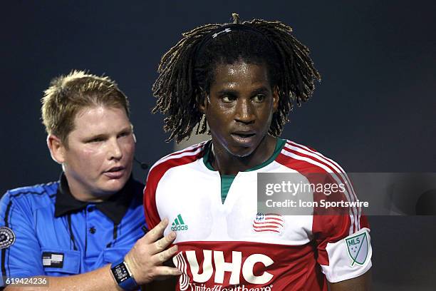 New England's Femi Hollinger-Janzen gets talked to by referee Kevin Terry, Jr. . The Carolina RailHawks hosted the New England Revolution at WakeMed...