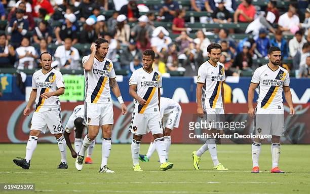 Landon Donovan, Alan Gordon, Giovani dos Santos, Baggio Husidic and Sebastian Lletget of Los Angeles Galaxy walk to midfield after breaking from...