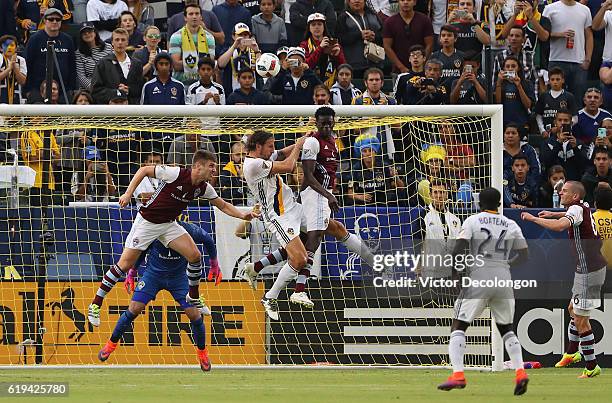 Kevin Doyle and Dominique Badji of Colorado Rapids and Alan Gordon of Los Angeles Galaxy vie for the ball near the goal box as Ema Boateng of Los...