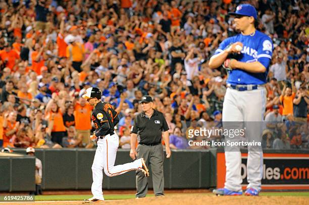 Baltimore Orioles third baseman Ryan Flaherty rounds the bases following his home run against Toronto Blue Jays relief pitcher Roberto Osuna at...
