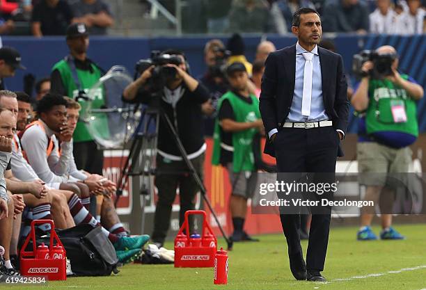 Head Coach Pablo Mastroeni of the Colorado Rapids looks on from his team's bench area during leg one of the Audi 2016 MLS Cup Playoff Western...