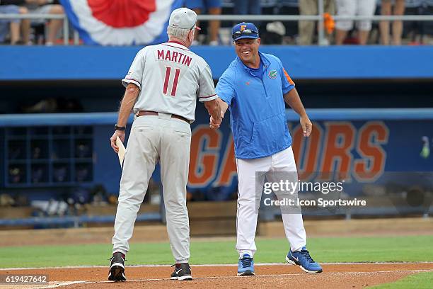 S Head Coach Mike Martin shakes hands with UF's Head Coach Kevin O'Sullivan before the NCAA Super Regional game between the Florida State Seminoles...