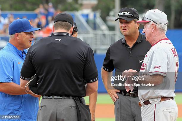 S Head Coach Kevin O'Sullivan meet with the umpires and FSU's Head Coach Mike Martin before the NCAA Super Regional game between the Florida State...