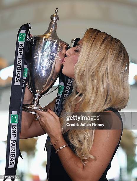 Champion Dominika Cibulkova of Slovakia kisses the Billie Jean King trophy after her victory against Angelique Kerber of Germany at Clifford Pier on...