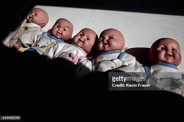 Plastic babies used in instruction to teach Chinese women to be qualified nannies, known in China as ayis, are seen on a table at the Ayi University...