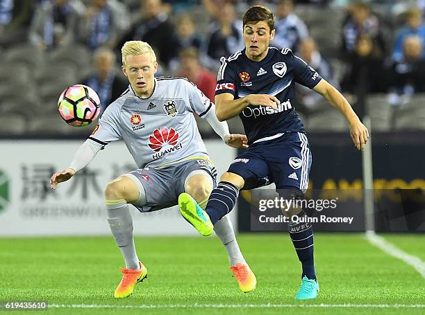 Marco Rojas of the Victory passes the ball infront of Adam Parkhouse of the Phoenix during the round four A-League match between the Melbourne...