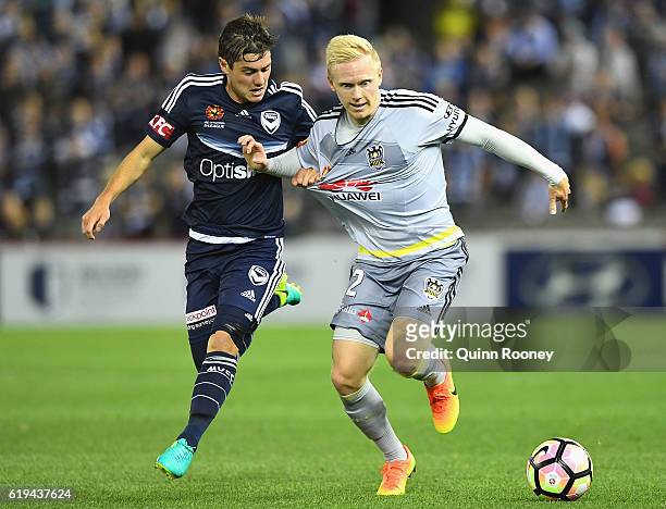 Marco Rojas of the Victory and Adam Parkhouse of the Phoenix compete for the ball during the round four A-League match between the Melbourne Victory...