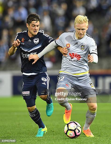 Marco Rojas of the Victory and Adam Parkhouse of the Phoenix compete for the ball during the round four A-League match between the Melbourne Victory...