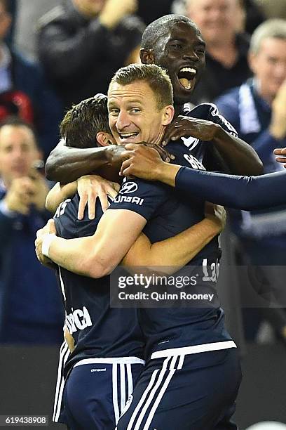 Marco Rojas of the Victory is congratulated by Besart Berisha and Jason Geria after scoring a goal during the round four A-League match between the...