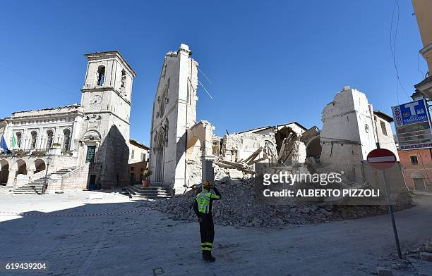 Firefighter stands in front of the destroyed Basilica of St Benedict in the historic center of Norcia, on October 31 a day after a 6.6 magnitude...