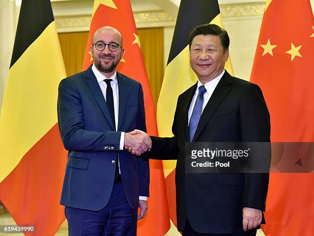 Belgian Prime Minister Charles Michel shakes hands with Chinese President Xi Jinping ahead of their meeting at the Great Hall of the People on...