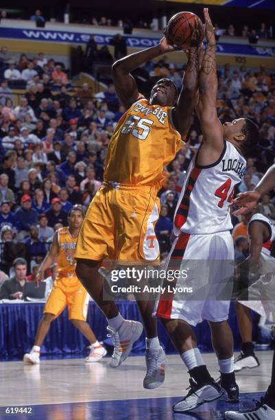 Charles Hathaway of the Tennessee Volunteers tries to shoot the ball against Rahim Lockhart of the Ole Miss Rebels during the SEC Tournament game in...