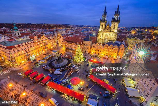view from above on traditional christmas market at old town square illuminated and decorated for holidays in prague - capital of czech republic. - prague christmas market old town stock-fotos und bilder