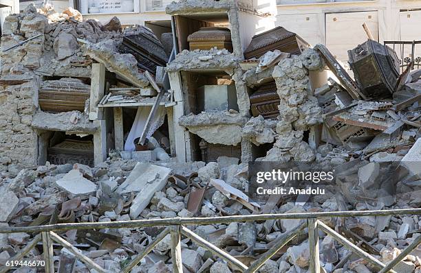 Coffins are seen out of their niches in the collapsed cemetery of the village of Campi, Italy, the day after the earthquake that hit central Italy,...
