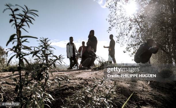 Young migrants are pictured in the 'Jungle' migrant camp, in Calais, northern France, on October 31 during a massive operation to clear the squalid...