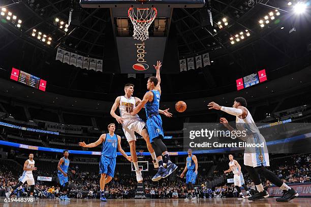 Juancho Hernangomez passes the ball to Jarnell Stokes of the Denver Nuggets during an NBA preseason game against the Dallas Mavericks on October 21,...