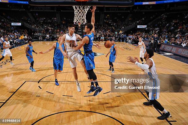 Juancho Hernangomez passes the ball to Jarnell Stokes of the Denver Nuggets during an NBA preseason game against the Dallas Mavericks on October 21,...