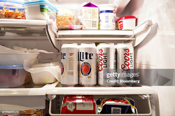 Cans of Molson Coors Brewing Co. Miller Lite and Coors Light brand beer are arranged for a photograph in a refrigerator in Princeton, Illinois, U.S.,...