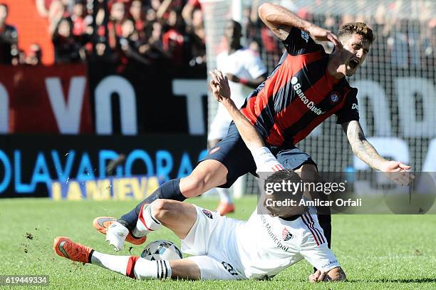 Emanuel Amoroso of Newell's Old Boys and Marcos Senesi of San Lorenzo fight for the ball during a match between Newell's Old Boys and San Lorenzo as...