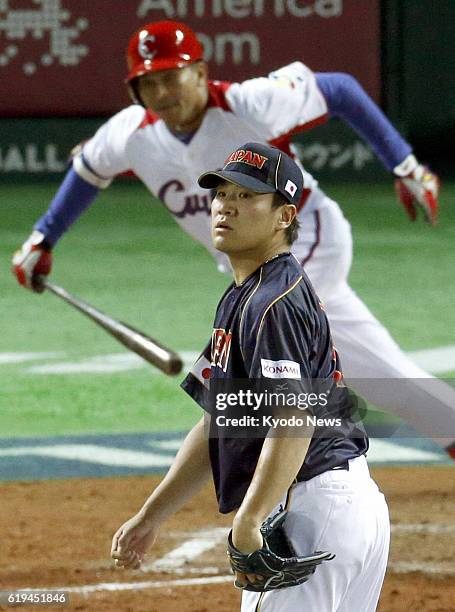 Japan - Japan pitcher Masahiro Tanaka watches the ball after Cuba's Frederich Cepeda hits an RBI double in the fourth inning of a World Baseball...