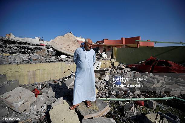 Local resident wanders around wrecked buildings after Iraqi Kurdish Regional Government's peshmerga forces recapture Faziliyah Village as the...