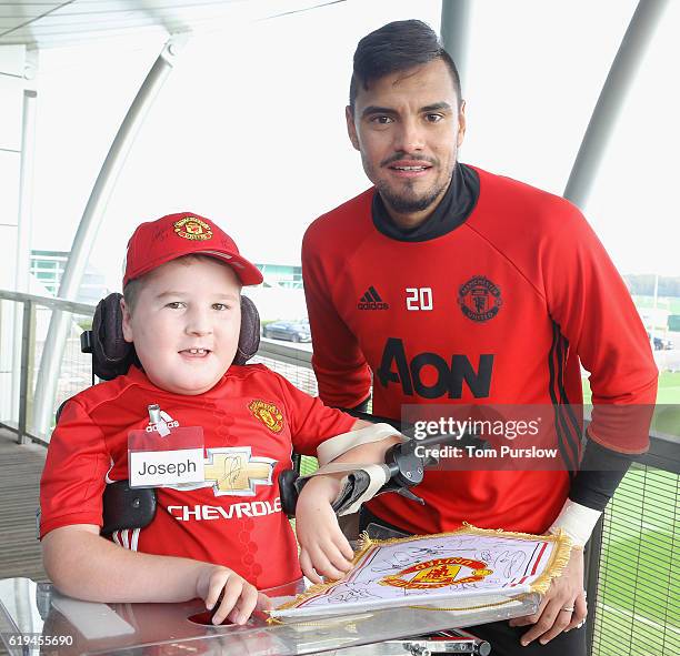 Sergio Romero of Manchester United poses with Joseph from Poynton at the MU Foundation Dream Day Meet and Greet at Aon Training Complex on October...