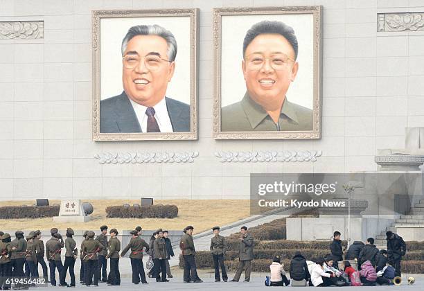 North Korea - North Koreans take part in a rehearsal for an event in Pyongyang's Kim Il Sung Square on March 8, 2013. Hanging from the wall are...