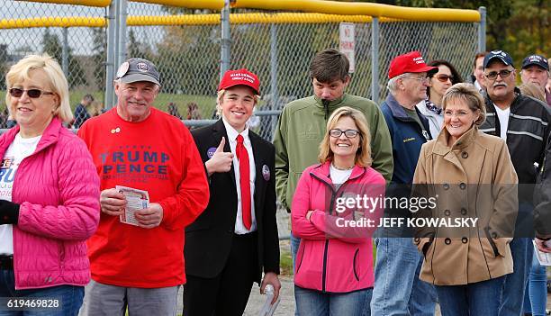 James Huffman is dressed up as US Republican presidential nominee Donald Trump as he waits to see him speak at Macomb Community College on October...