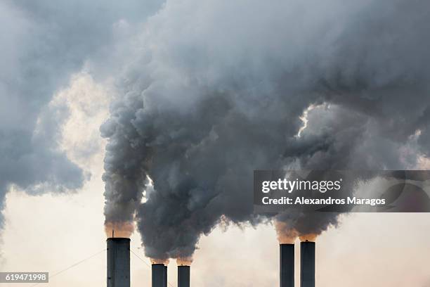 smoke emerging from chimneys - factory smog stock pictures, royalty-free photos & images