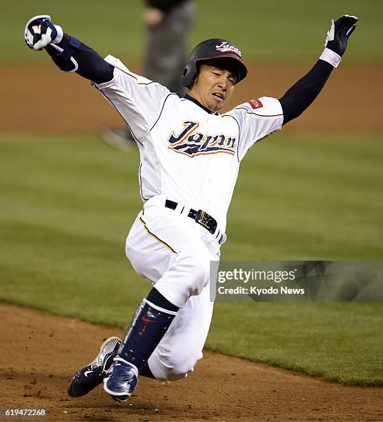 United States - Takashi Toritani of Japan slides into third base for a triple during the eighth inning of the World Baseball Classic semifinal...