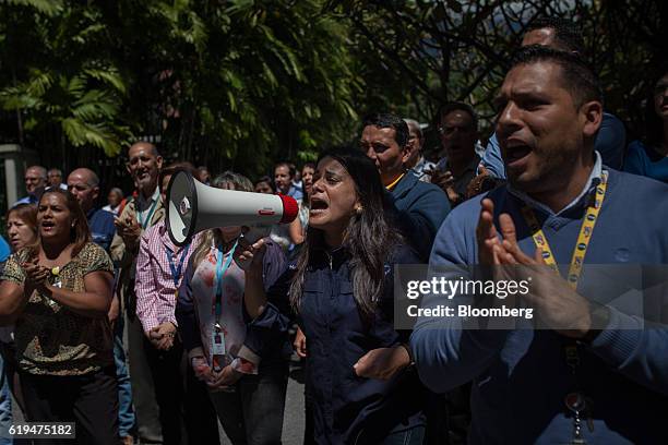 Empresas Polar SA employees shout as the company's Chief Executive Officer Lorenzo Mendoza, not pictured, speaks during a news conference outside the...