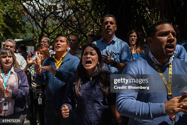 Empresas Polar SA employees shout as the company's Chief Executive Officer Lorenzo Mendoza, not pictured, speaks during a news conference outside the...