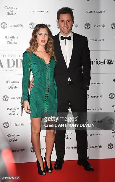 Manchester United's Spanish midfielder Ander Herrera and partner Isabel Collado pose on the red carpet as they arrive to attend the "United for...