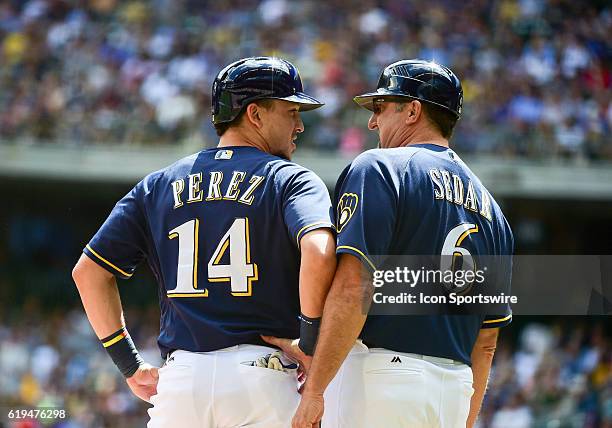 Milwaukee Brewers third base coach Ed Sedar talks with Milwaukee Brewers second baseman Hernan Perez during a MLB game Between the Cincinnati Reds...