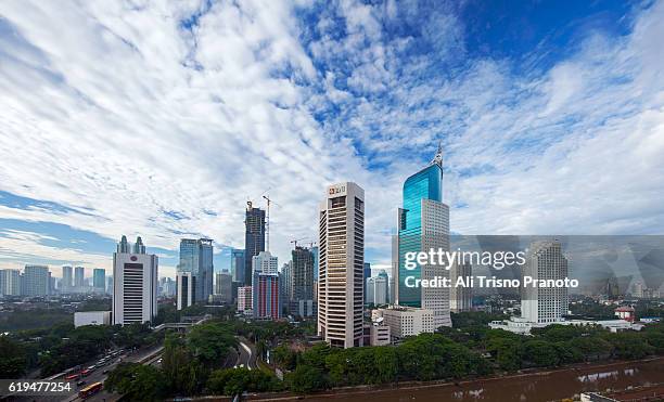 jakarta skyline with iconic bni tower in clear morning. jakarta city, indonesia. - jakarta stock pictures, royalty-free photos & images