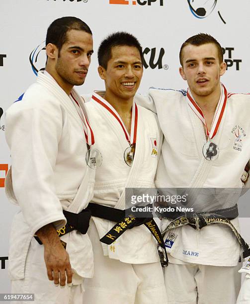 Switzerland - Three-time Olympic judo champion Tadahiro Nomura of Japan stands on the podium after winning the men's judo 60-kilogram category at the...