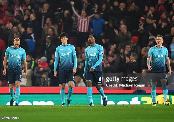 Mike van der Hoorn, Leroy Fer, Ki Sung-Yueng and Alfie Mawson of Swansea City look dejected as Wifried Bony of Stoke City scores the first goal...