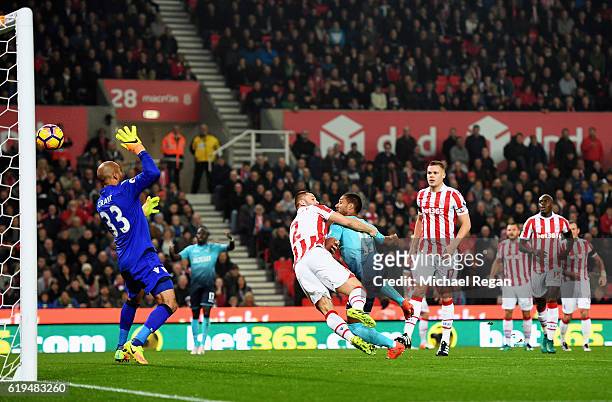 Wayne Routledge of Swansea City beats Phil Bardsley of Stoke City to score their first goal past goalkeeper Lee Grant of Stoke City during the...