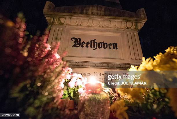 Candles and flowers decorate the grave of famous German composer Ludwig van Beethoven at Vienna's Central Cemetery on the eve of All Saints Day in...
