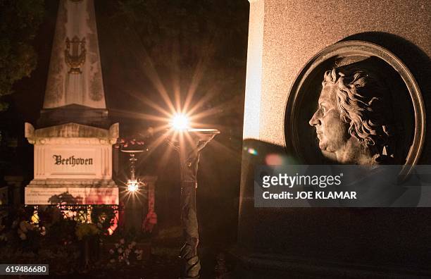 Candles and flowers decorate the grave of famous German composers Ludwig van Beethoven and the memorial of Wolfgang Amadeus Mozart at Vienna's...