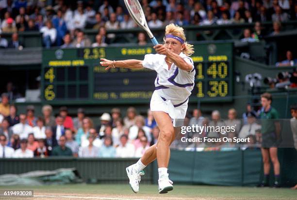 Martina Navratilova of Czechoslovakia hits a return against Zina Garrison-Jackson of the United States during the finals of the women's singles at...