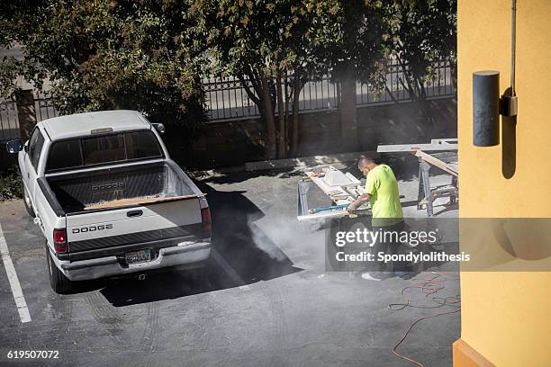 mexican worker cutting granite without any protection - respiratory protection construction stock pictures, royalty-free photos & images