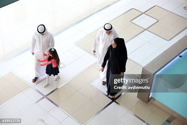 arabian family in shopping mall - emirati family shopping stock pictures, royalty-free photos & images