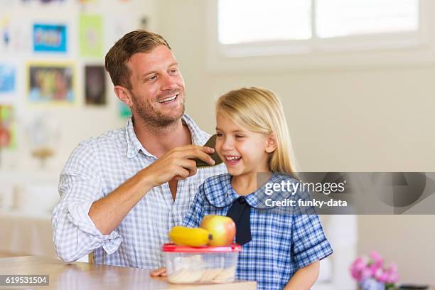 father preparing daughter for school - guy combing hair stock pictures, royalty-free photos & images