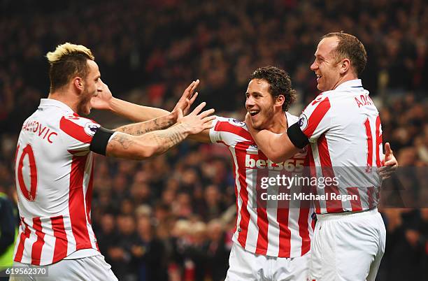 Marko Arnautovic, Ramadan Sobhi and Charlie Adam of Stoke City celebrate as Alfie Mawson of Swansea City scores an own goal for their second goal...